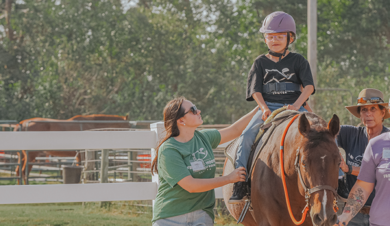 Boy with glasses Riding a horse