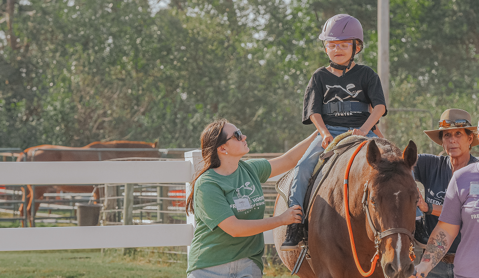 Boy with glasses Riding a horse