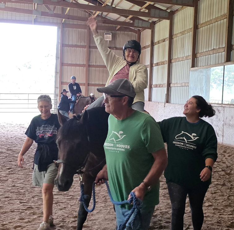 an old lady riding in barn