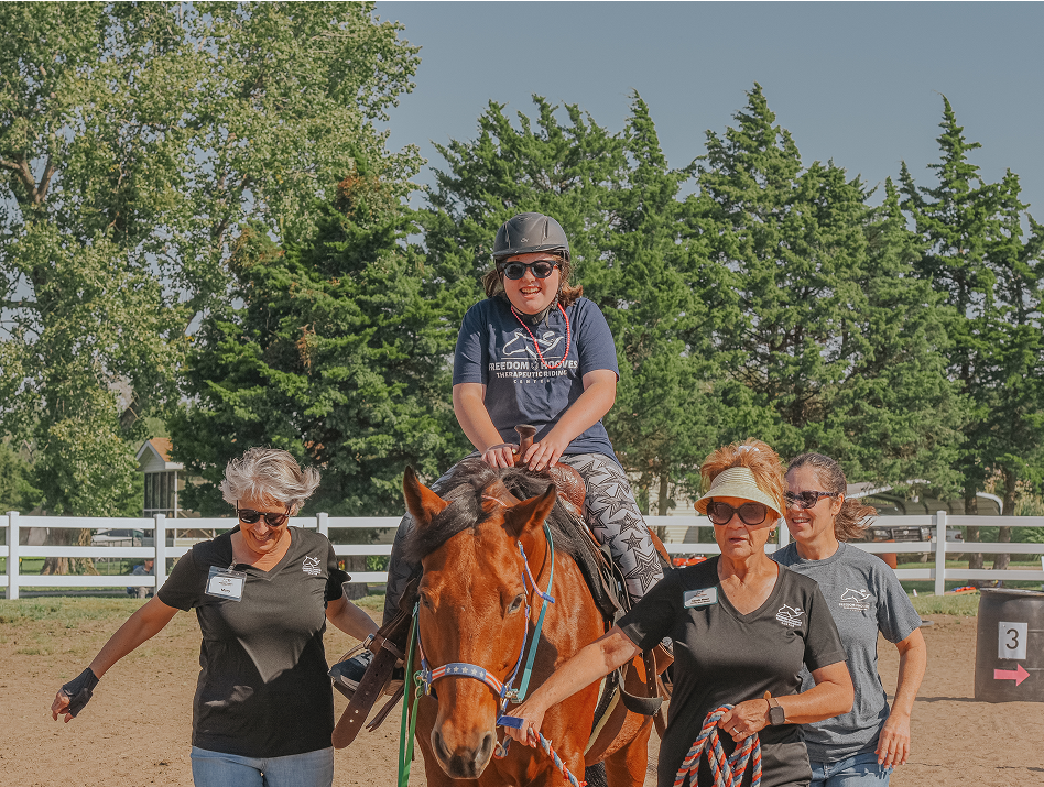 women with horse and one is riding