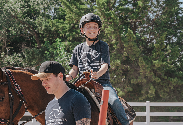 young boy riding a horse