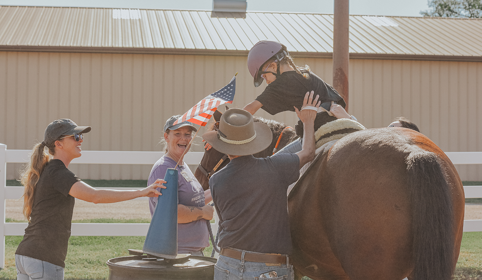 volunteers are helping a boy ro ride